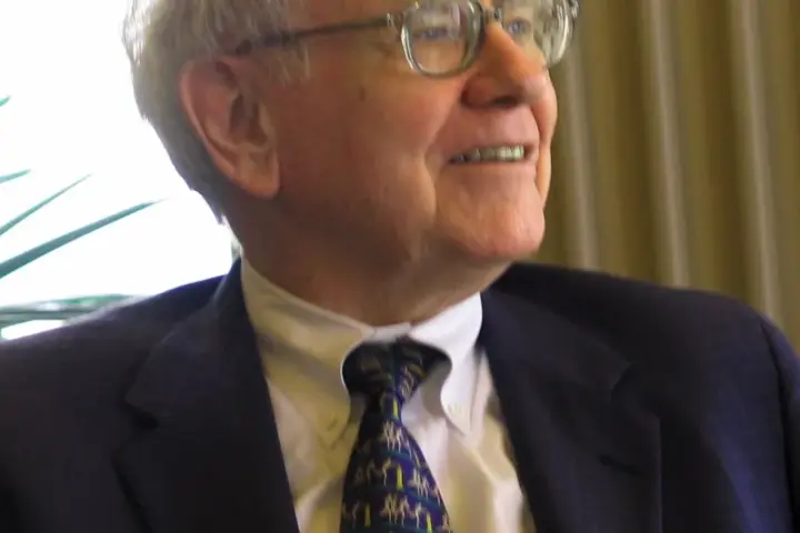 Close-up portrait photograph of investor Warren Buffett speaking during a public appearance.