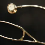 A stethoscope resting on a flat surface, representing employer-sponsored health insurance premiums and out-of-pocket costs