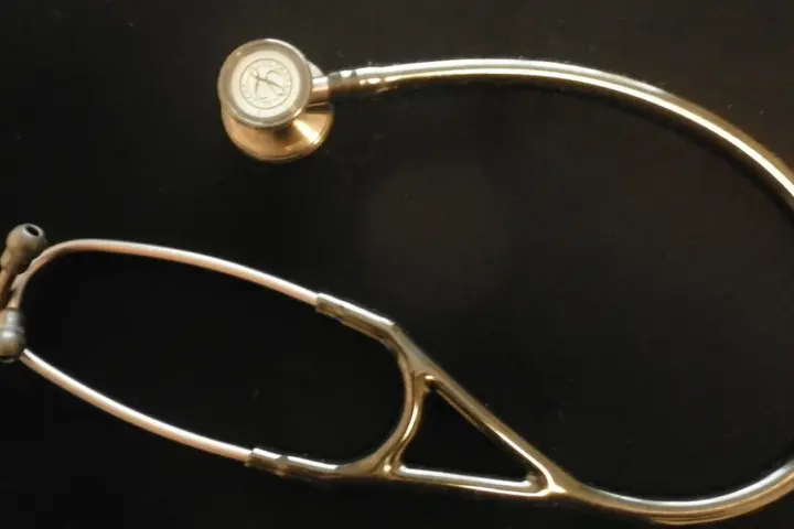 A stethoscope resting on a flat surface, representing employer-sponsored health insurance premiums and out-of-pocket costs