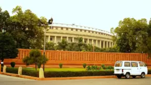Exterior of India’s circular Parliament building in New Delhi under a blue sky.