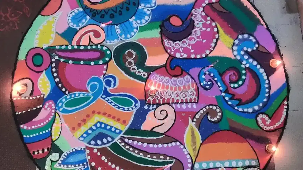 Colourful homemade rangoli design arranged on a floor for Diwali.