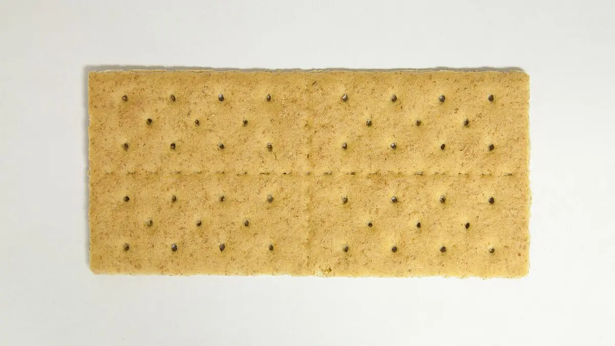 Stack of plain rectangular graham crackers on a white background.