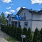 Photograph of a residential home with a real estate sign outside.