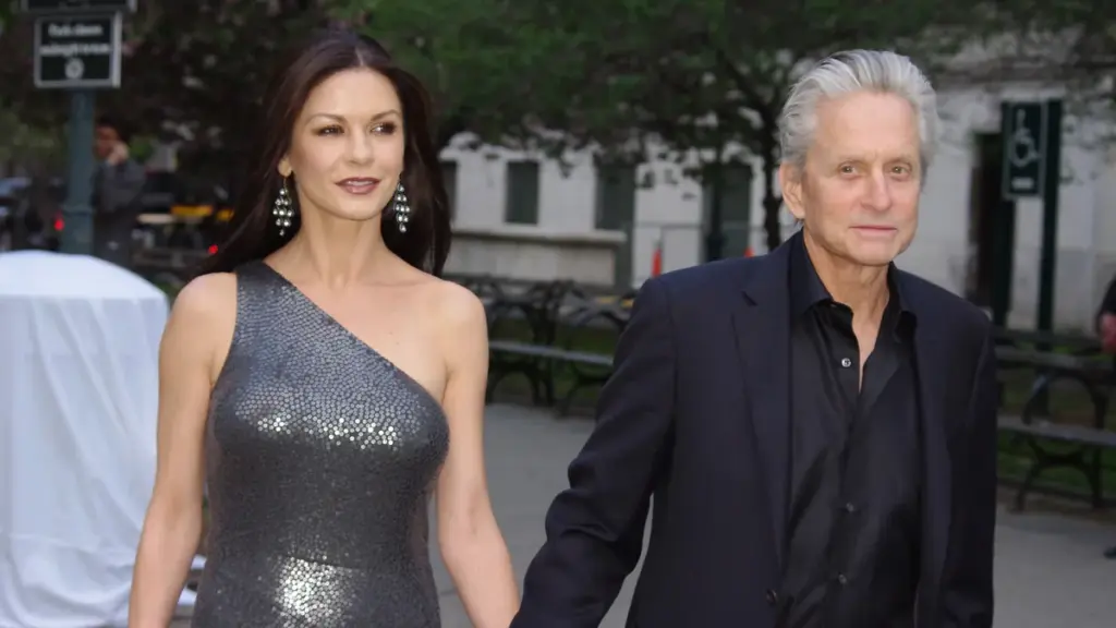 Red carpet photograph of actors Catherine Zeta-Jones and Michael Douglas standing together at a public film event.