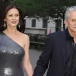 Red carpet photograph of actors Catherine Zeta-Jones and Michael Douglas standing together at a public film event.