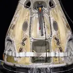 A SpaceX Crew Dragon capsule after splashdown during a NASA recovery operation.