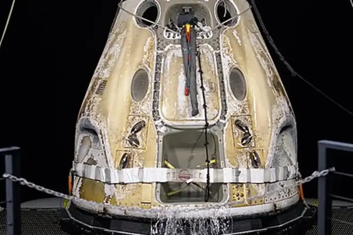 A SpaceX Crew Dragon capsule after splashdown during a NASA recovery operation.