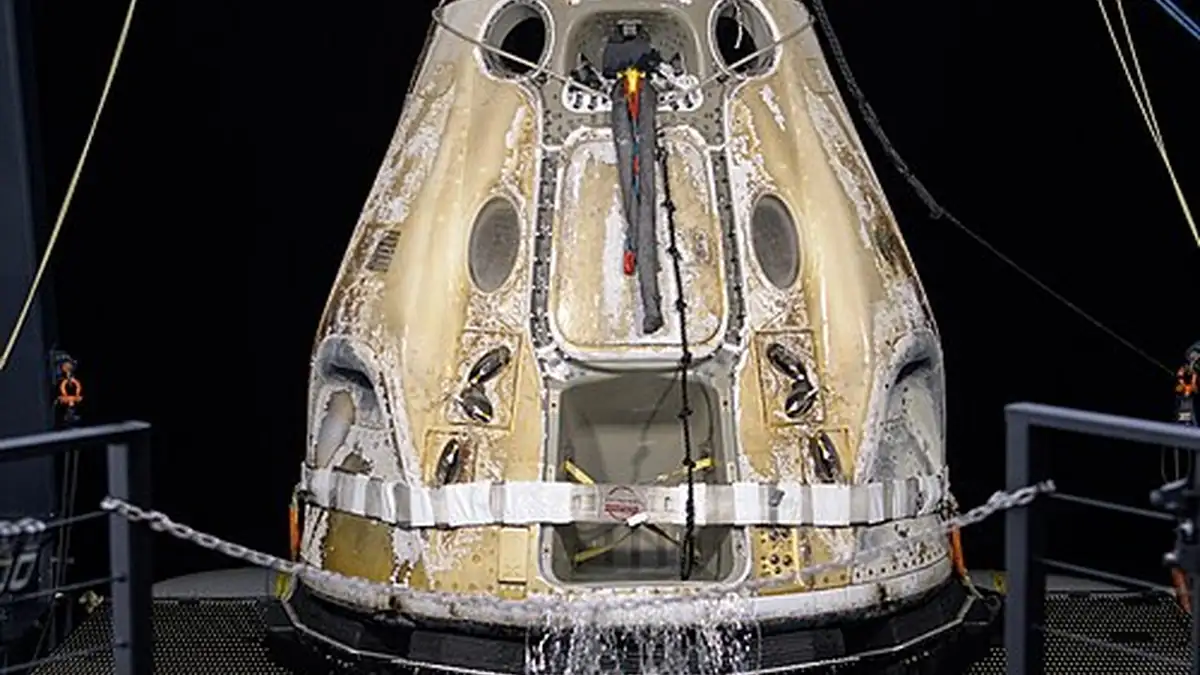 A SpaceX Crew Dragon capsule after splashdown during a NASA recovery operation.