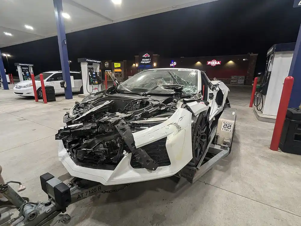 Damaged Corvette C8 on trailer after test-drive crash