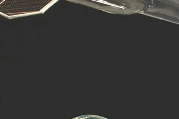 Orbital view from the X-37B spaceplane showing spacecraft hardware, a solar array and Earth below.