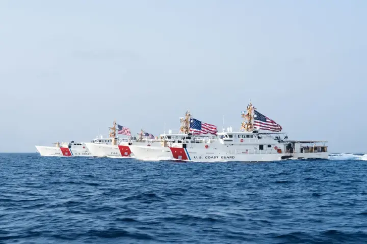 Three U.S. Coast Guard fast-response cutters travel through the Strait of Hormuz.