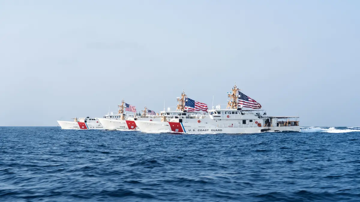 Three U.S. Coast Guard fast-response cutters travel through the Strait of Hormuz.