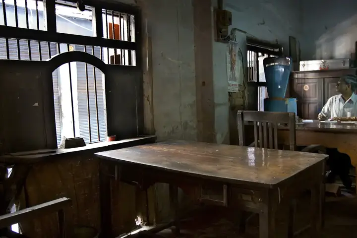 Interior of a government office with civil servants working at desks with official documents and equipment