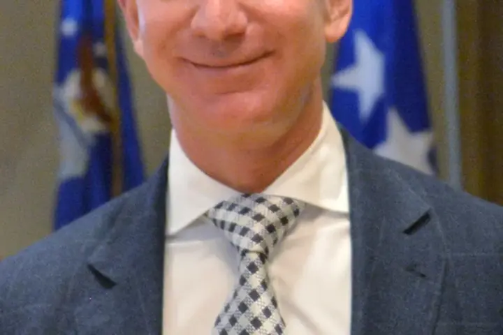 Close-up photograph of Amazon and Blue Origin founder Jeff Bezos speaking during an official policy and industry presentation.
