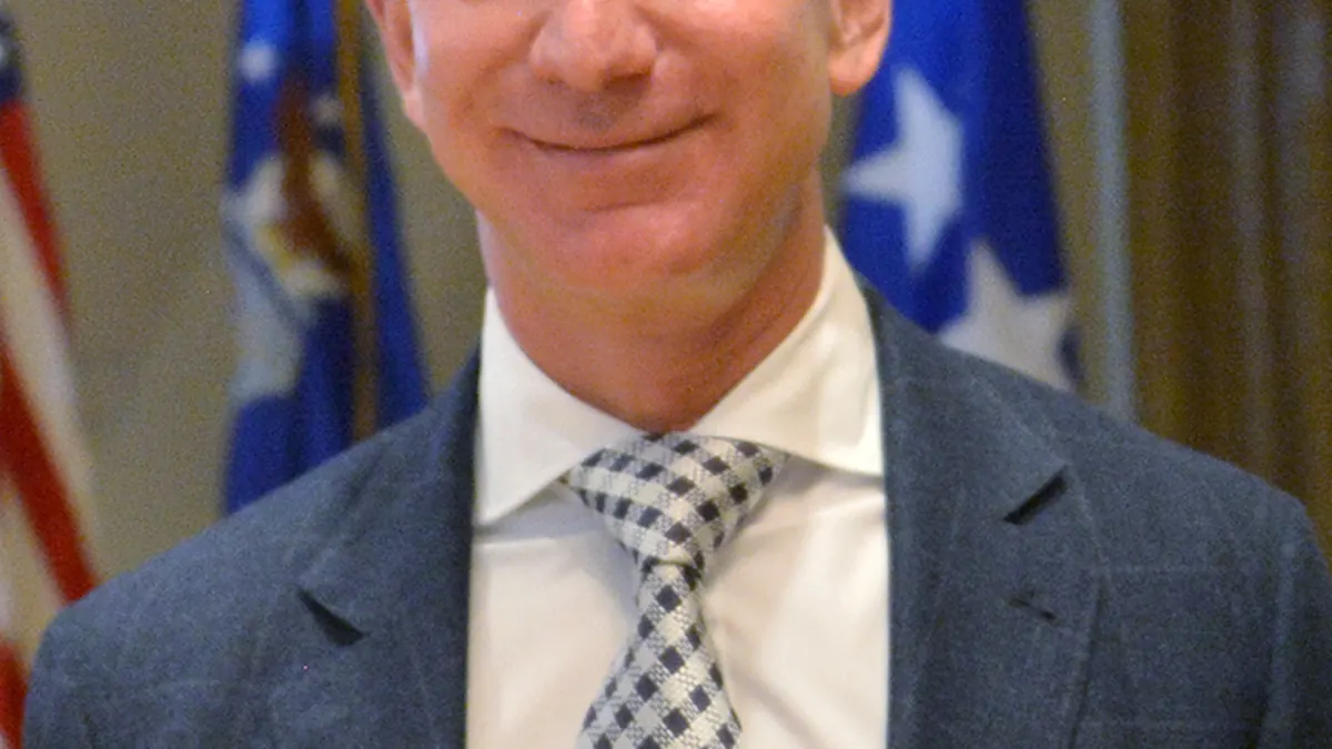 Close-up photograph of Amazon and Blue Origin founder Jeff Bezos speaking during an official policy and industry presentation.