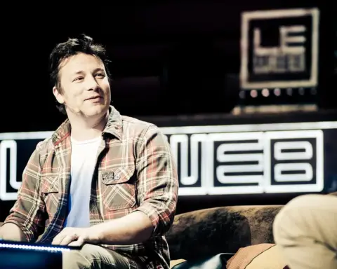 Photograph of Jamie Oliver speaking in front of stage lights during a public discussion at Central Hall Westminster in London