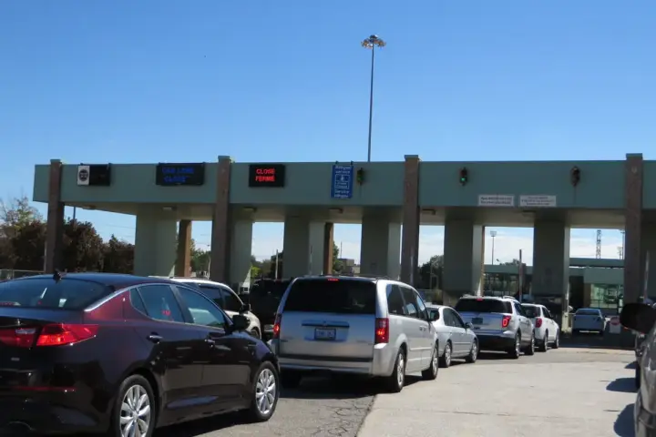 The Ambassador Bridge suspension bridge connecting Detroit Michigan and Windsor Ontario, representing the Canada-US international border and trade relationship