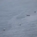 Small wooden fishing boats scattered across the water of the Bay of Bengal near Visakhapatnam