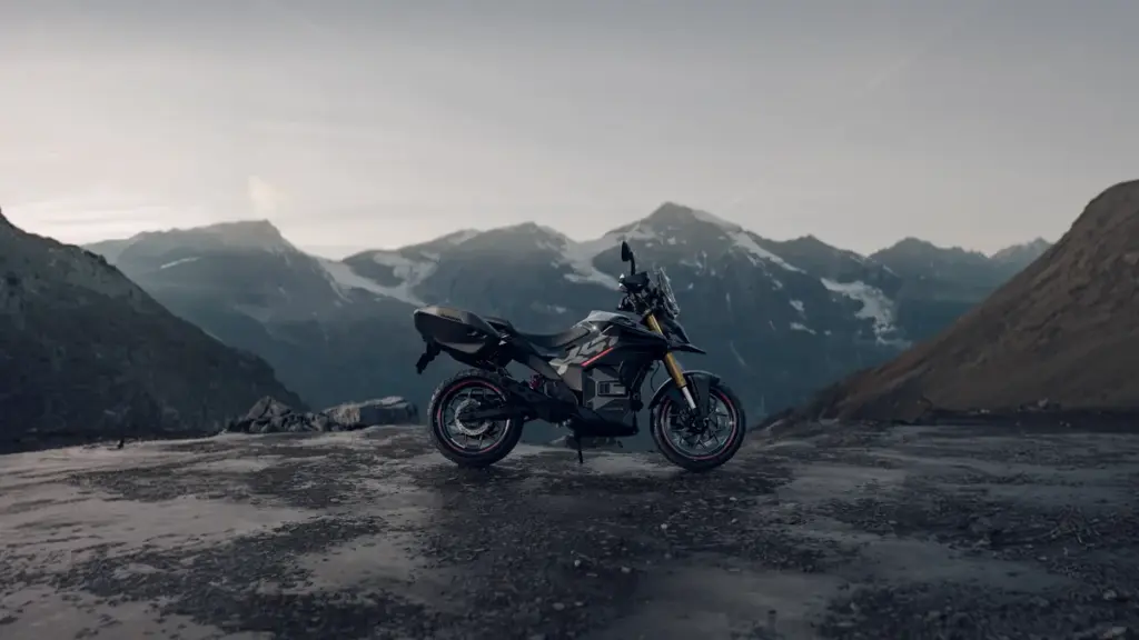 Side profile of the Ultraviolette X-47 electric motorcycle parked on a mountain pass
