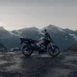 Side profile of the Ultraviolette X-47 electric motorcycle parked on a mountain pass