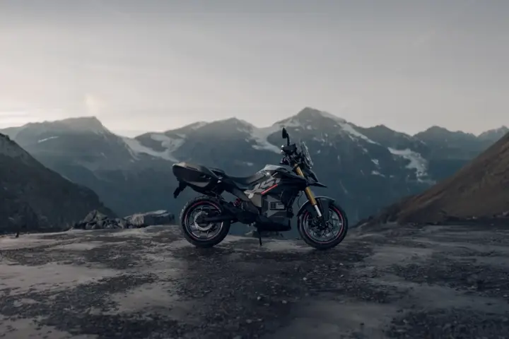 Side profile of the Ultraviolette X-47 electric motorcycle parked on a mountain pass