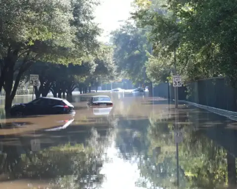 Cars floating on a flooded street in Houston, Texas