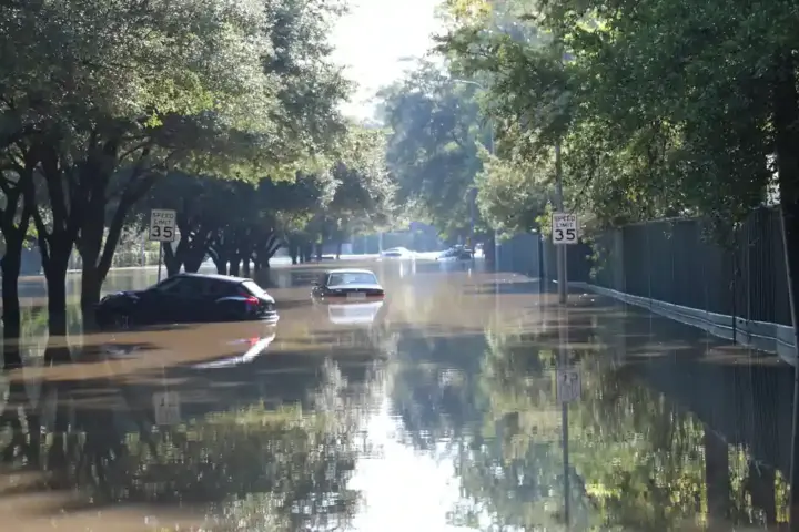 Cars floating on a flooded street in Houston, Texas