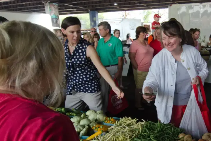 USDA photograph showing an EBT transaction at a Baltimore farmers market with fresh produce