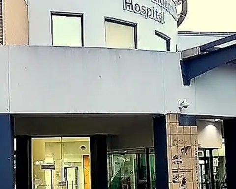 Exterior view of an Australian metropolitan public hospital brick and concrete building housing acute and inpatient wards.
