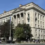 Exterior facade and classical colonnade of the Robert F. Kennedy Department of Justice headquarters building in Washington, D.C.