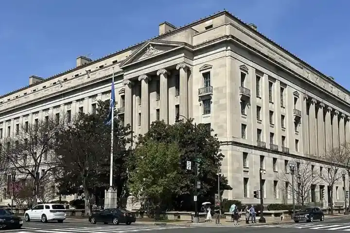 Exterior facade and classical colonnade of the Robert F. Kennedy Department of Justice headquarters building in Washington, D.C.