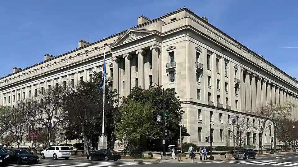 Exterior facade and classical colonnade of the Robert F. Kennedy Department of Justice headquarters building in Washington, D.C.