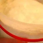 Glass of raw goat milk representing unpasteurized dairy products