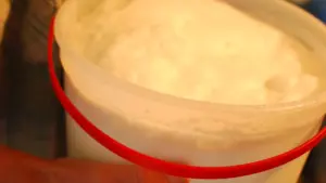 Glass of raw goat milk representing unpasteurized dairy products