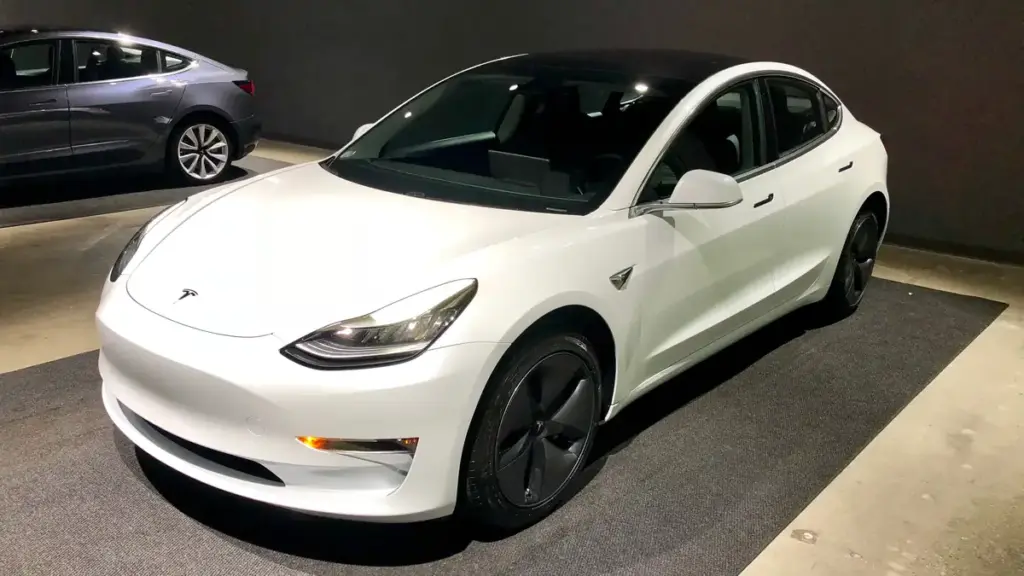 White Tesla Model 3 electric sedan photographed indoors.