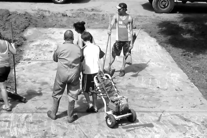 Volunteers cleaning mud and flood damage from a building.