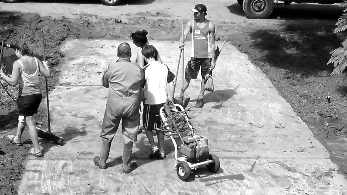 Volunteers cleaning mud and flood damage from a building.