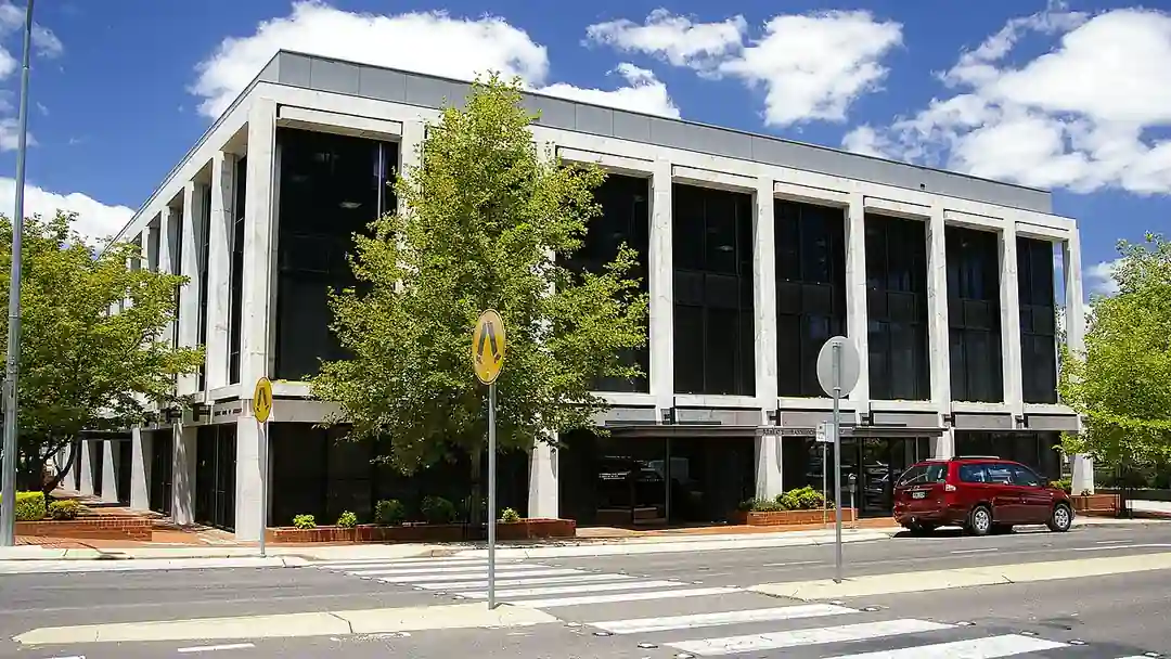 The Reserve Bank of Australia building in Canberra featuring structured concrete and glass architecture under daylight.