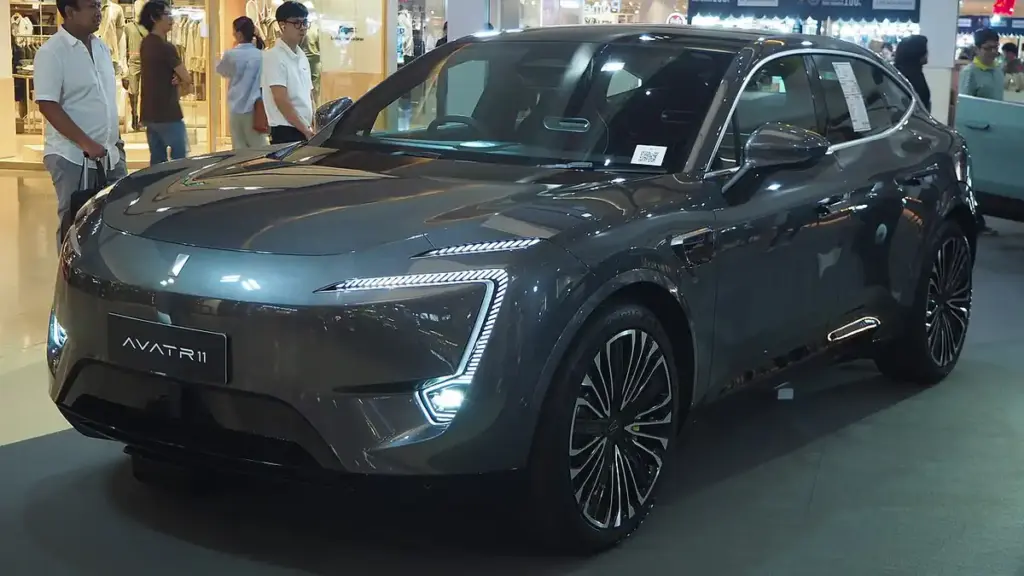 Three-quarter exterior profile of a modern metallic Avatr electric vehicle parked on city pavement.