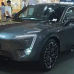 Three-quarter exterior profile of a modern metallic Avatr electric vehicle parked on city pavement.