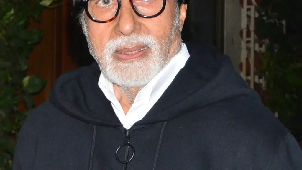 Indian actor Amitabh Bachchan photographed in close-up wearing a dark hooded jacket
