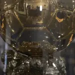 Close-up of the Ballon d'Or trophy on display at an award ceremony with ceremony lighting