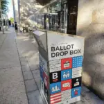 A secured ballot box situated inside an official election polling station.