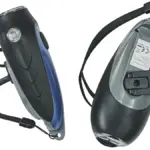 Two black hand-crank operated dynamo generator LED torches photographed for off-grid household emergency lighting.