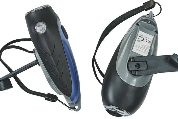 Two black hand-crank operated dynamo generator LED torches photographed for off-grid household emergency lighting.