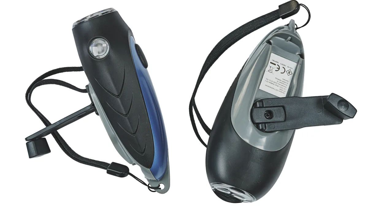 Two black hand-crank operated dynamo generator LED torches photographed for off-grid household emergency lighting.