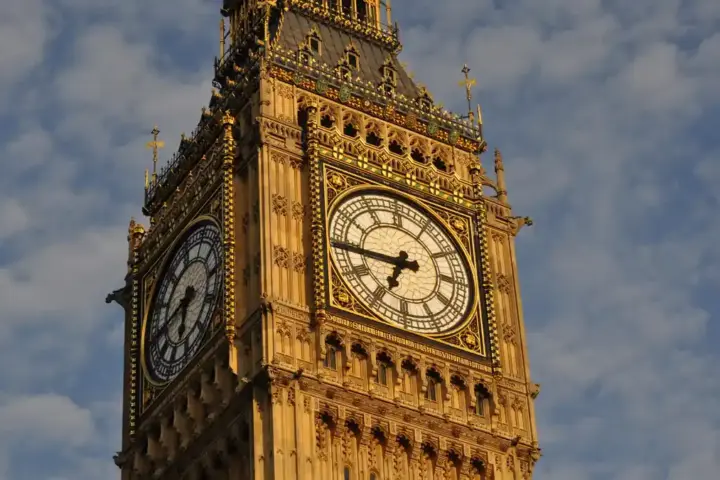 Detailed view of the clock face of Big Ben's Elizabeth Tower against a cloudy London sky