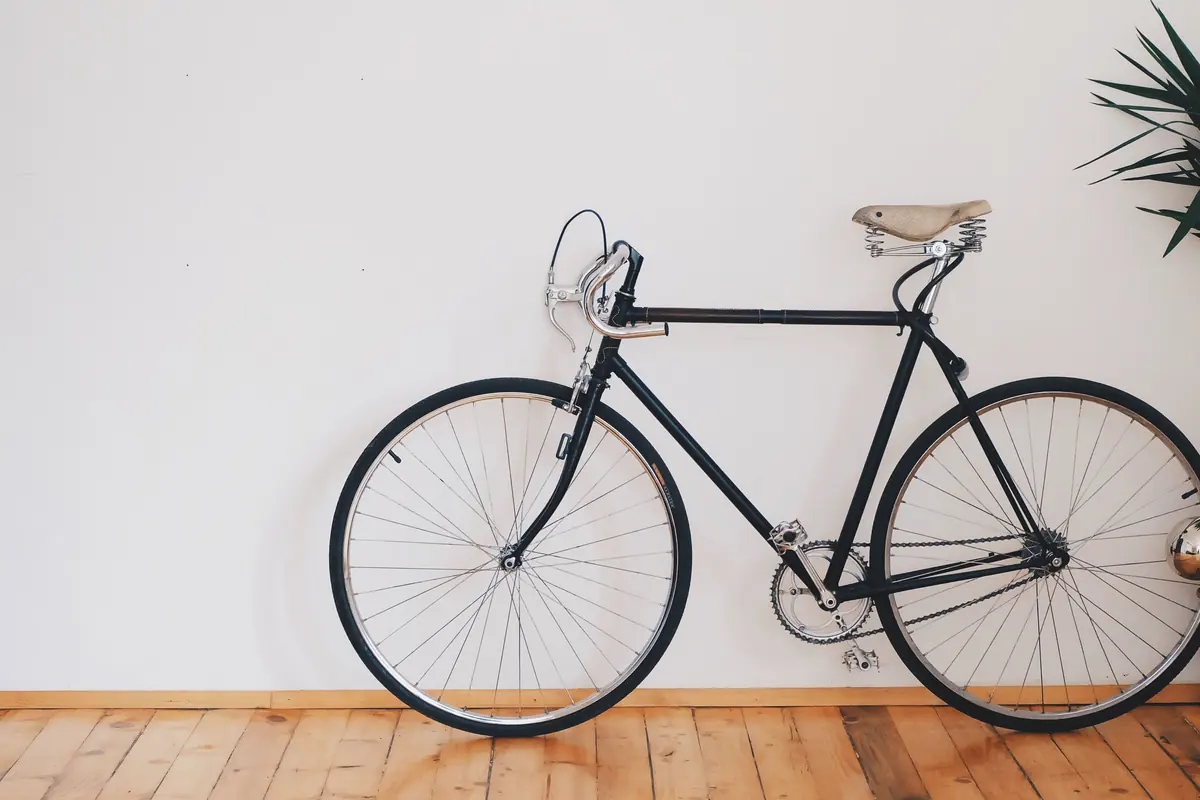 A bicycle shown in close-up with its frame and saddle visible.