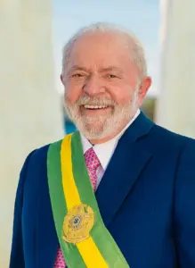 Official presidential portrait photograph of Brazilian President Luiz Inácio Lula da Silva wearing a dark suit and the green and yellow presidential sash.