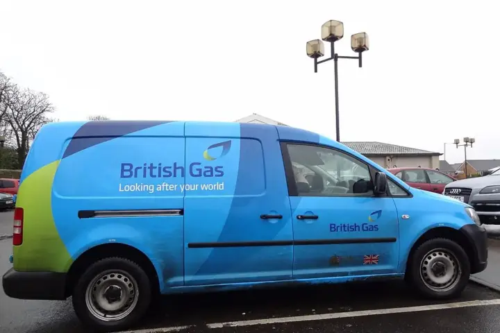 A blue British Gas fleet service vehicle parked along a residential pavement in the United Kingdom.